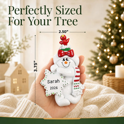 Size guide: the personalized Birdsnest Snow Woman christmas ornament is 2.50 in wide by 3.75 in tall, shown in hand