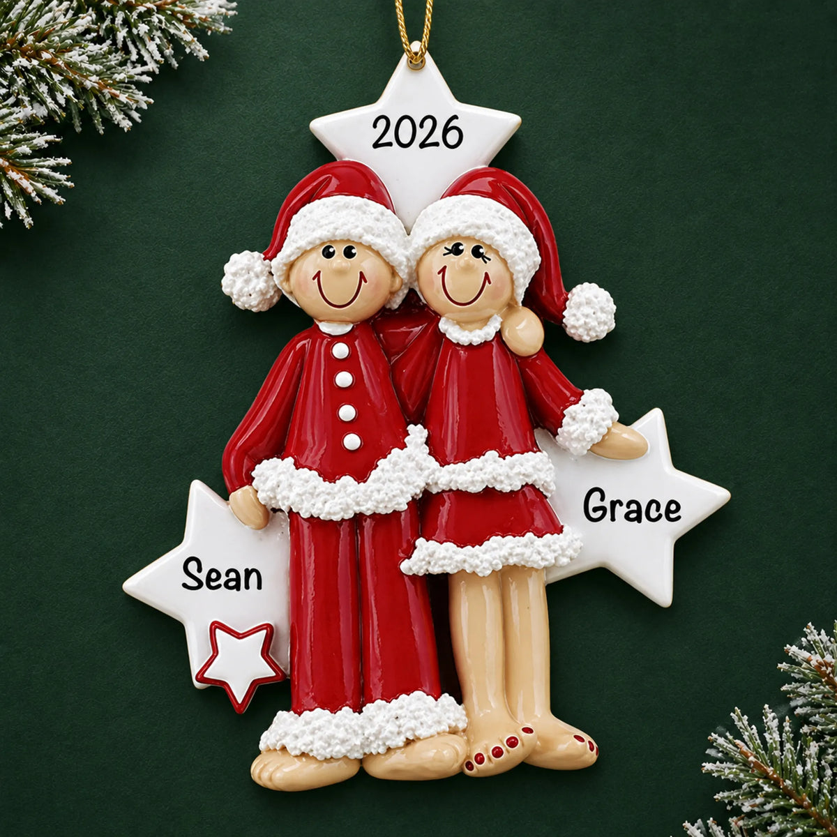 Personalized christmas pajama couple ornament on a dark green pine background