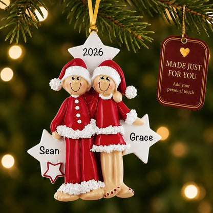 Christmas pajama couple ornament hanging on a lit Christmas tree with a Made Just For You gift tag
