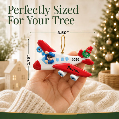 Size guide: the personalized airplane pilot christmas ornament is 3.50 in wide by 1.75 in tall, shown in hand