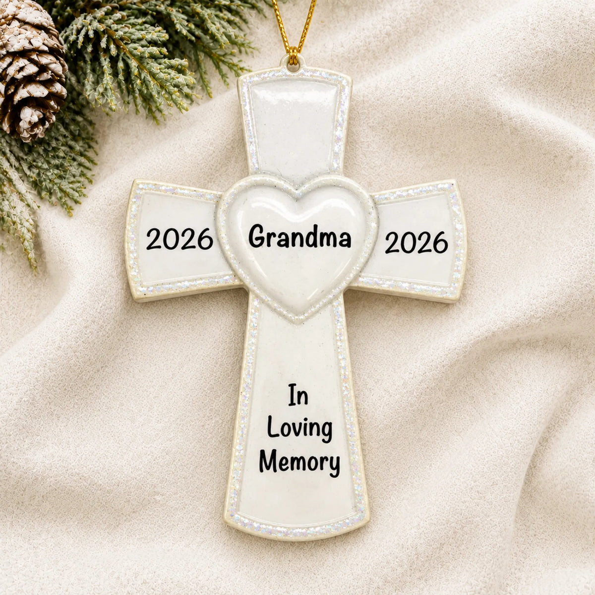 Personalized White Cross Memorial christmas ornament laid on a soft white knit blanket