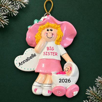 Personalized blonde big sister christmas ornament on a dark green pine background
