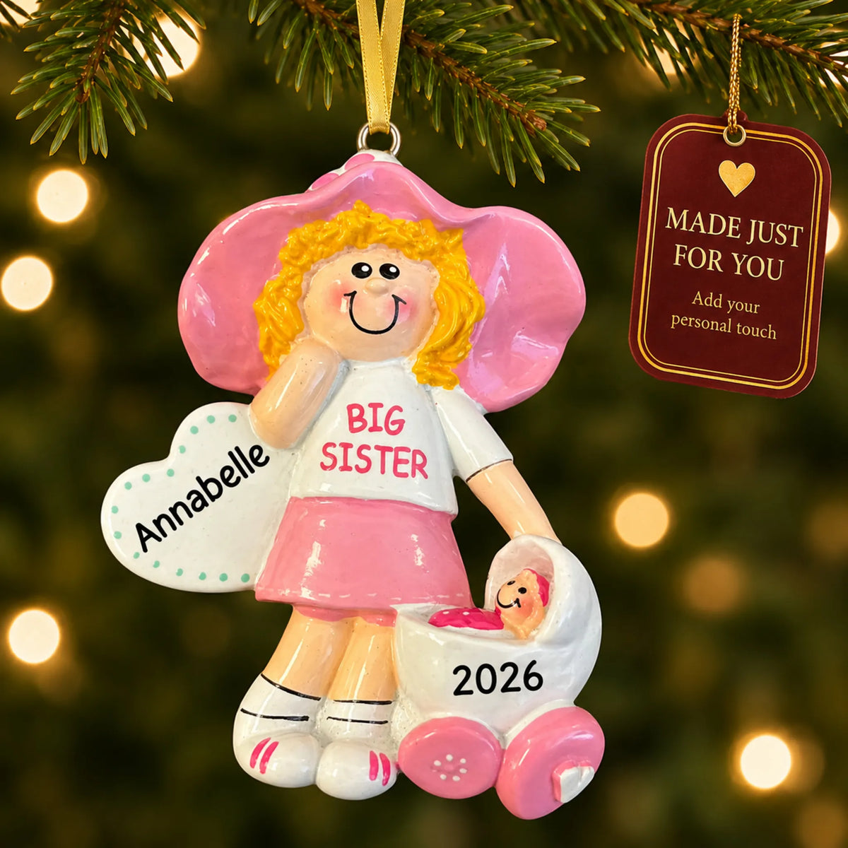 Blonde big sister christmas ornament hanging on a lit Christmas tree with a Made Just For You gift tag