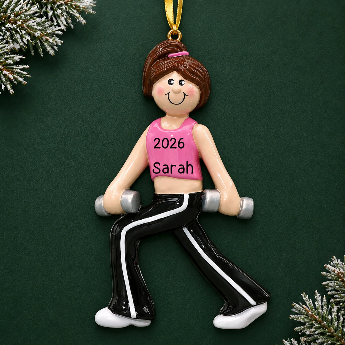Personalized female fitness christmas ornament on a dark green pine background