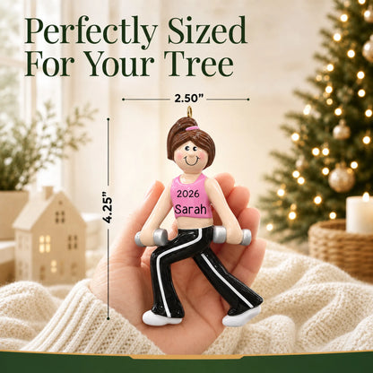 Size guide: the personalized female fitness christmas ornament is 2.50 in wide by 4.25 in tall, shown in hand