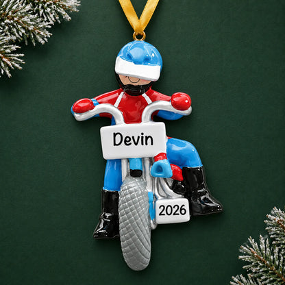 Personalized dirt bike rider christmas ornament on a dark green pine background