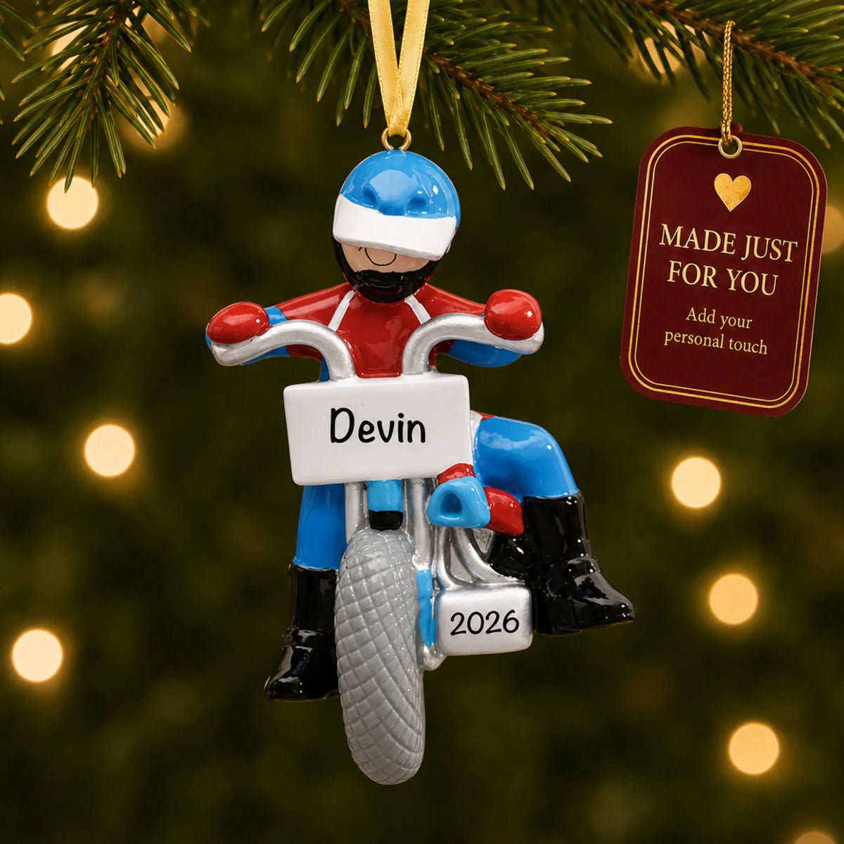Dirt bike rider christmas ornament hanging on a lit Christmas tree with a Made Just For You gift tag