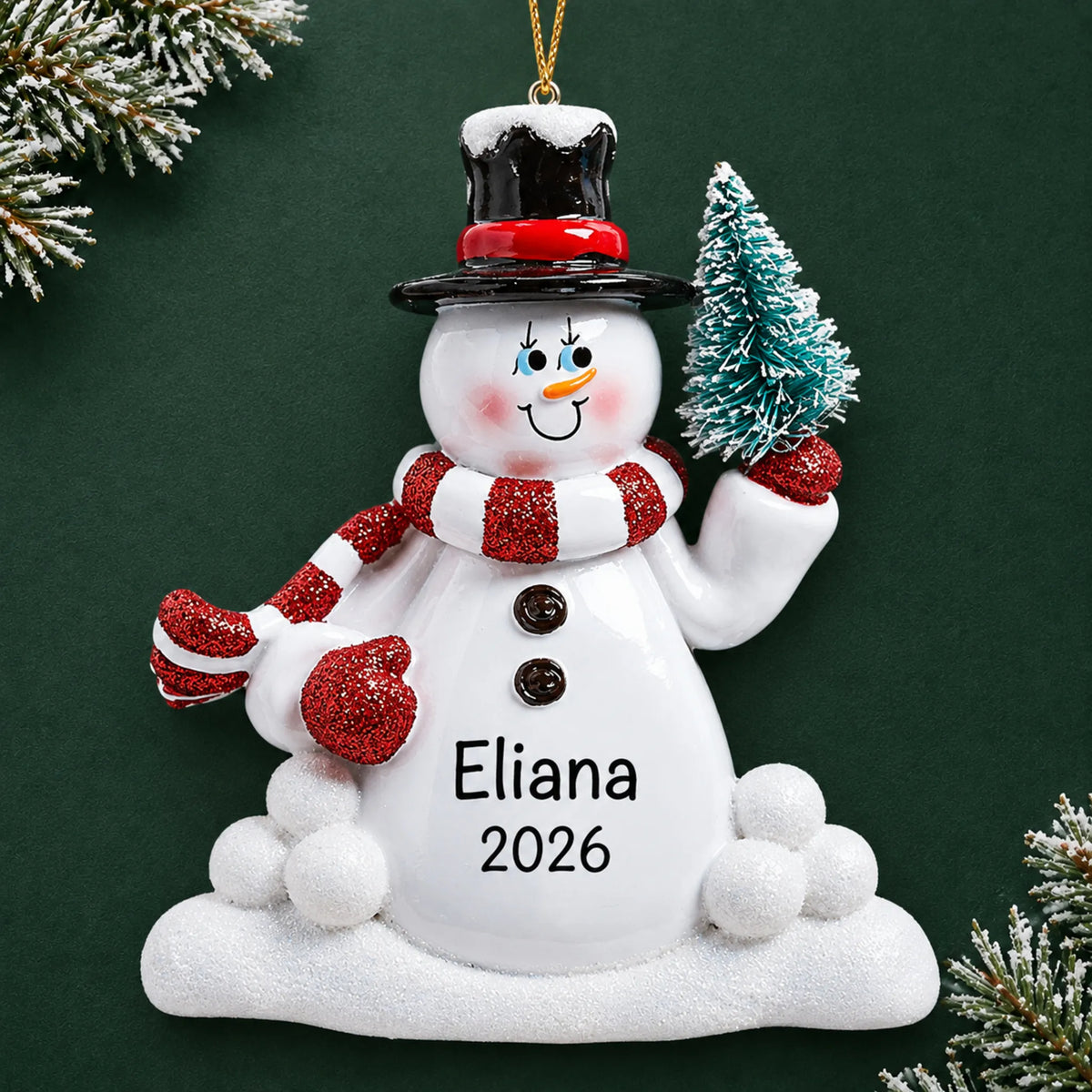 Personalized Snowman with Tree christmas ornament on a dark green pine background