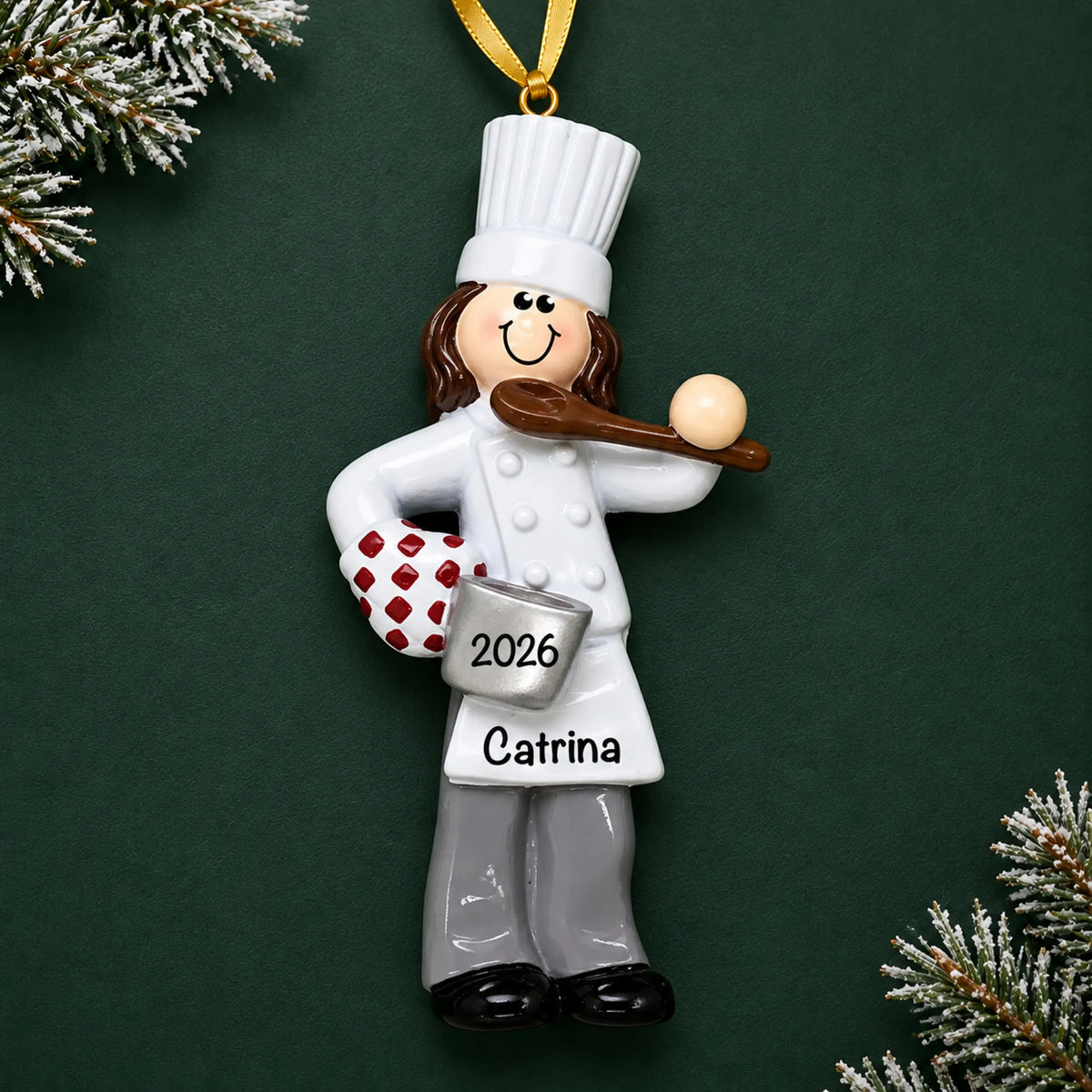 Personalized chef girl christmas ornament on a dark green pine background
