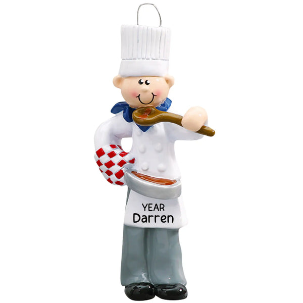 Personalized Christmas ornament featuring a male chef in a white toque and coat, holding a wooden spoon and a red checkered oven mitt, with the hat ready for custom name engraving.