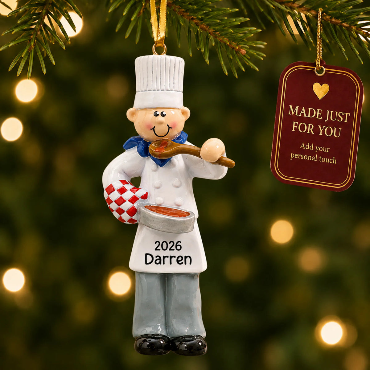 Chef guy christmas ornament hanging on a lit Christmas tree with a Made Just For You gift tag