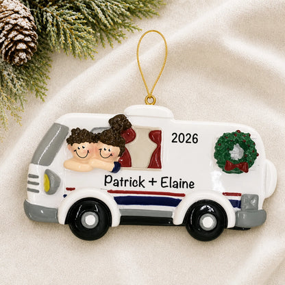 Personalized RV camping couple christmas ornament laid on a soft white knit blanket