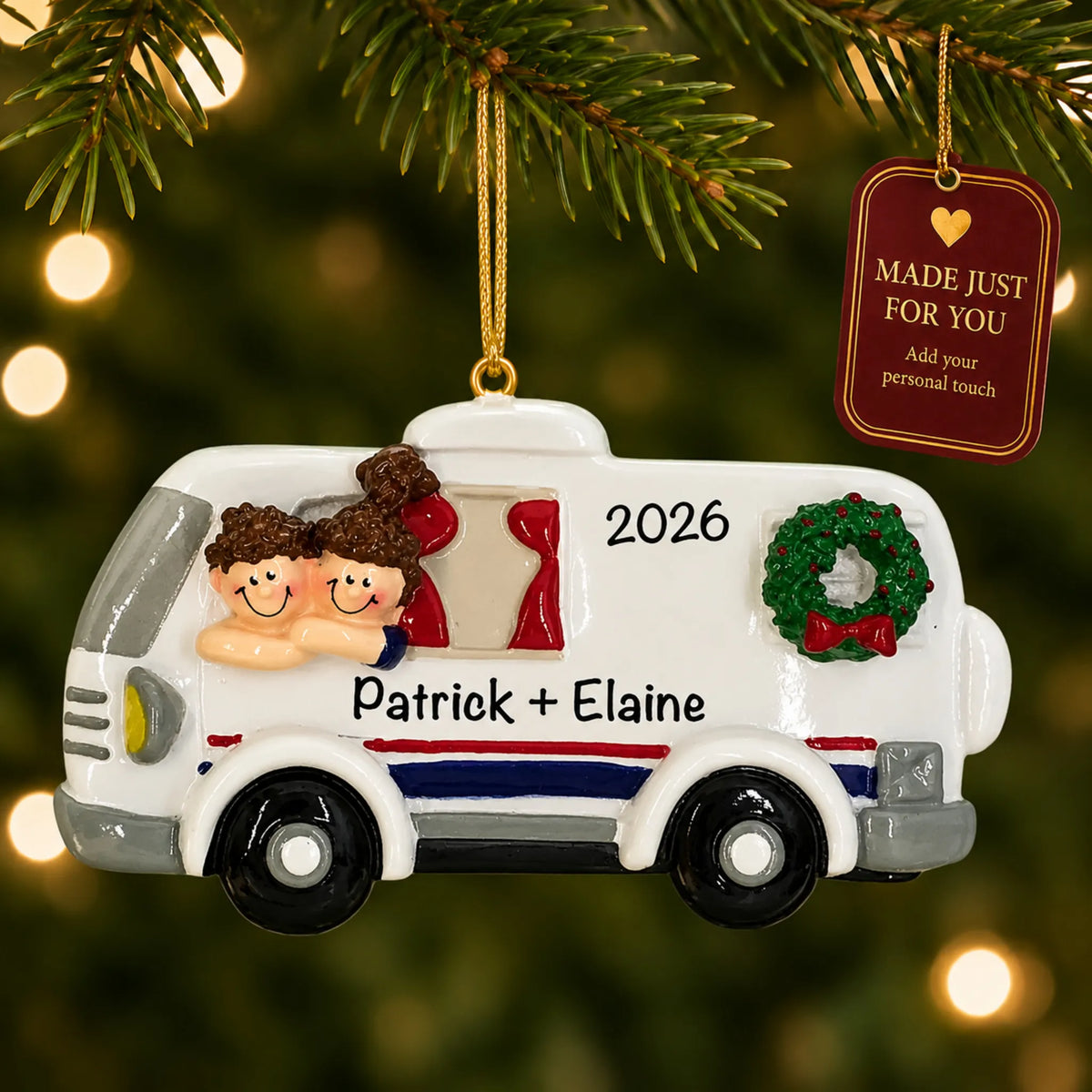 RV camping couple christmas ornament hanging on a lit Christmas tree with a Made Just For You gift tag