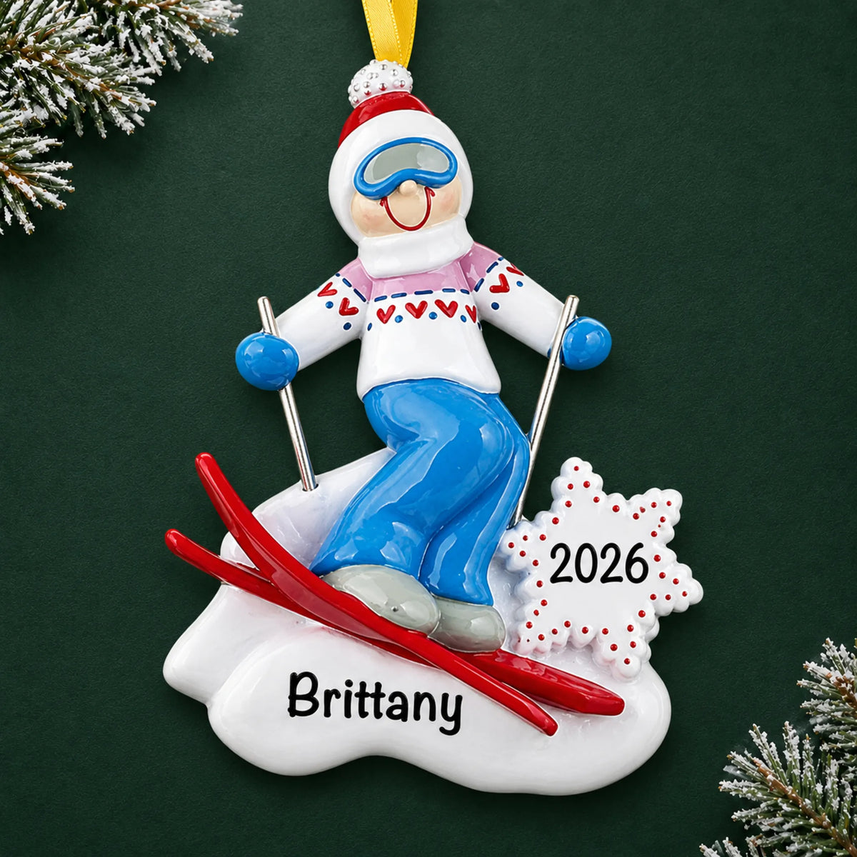 Personalized ski girl christmas ornament on a dark green pine background