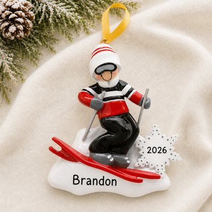 Personalized ski guy christmas ornament laid on a soft white knit blanket