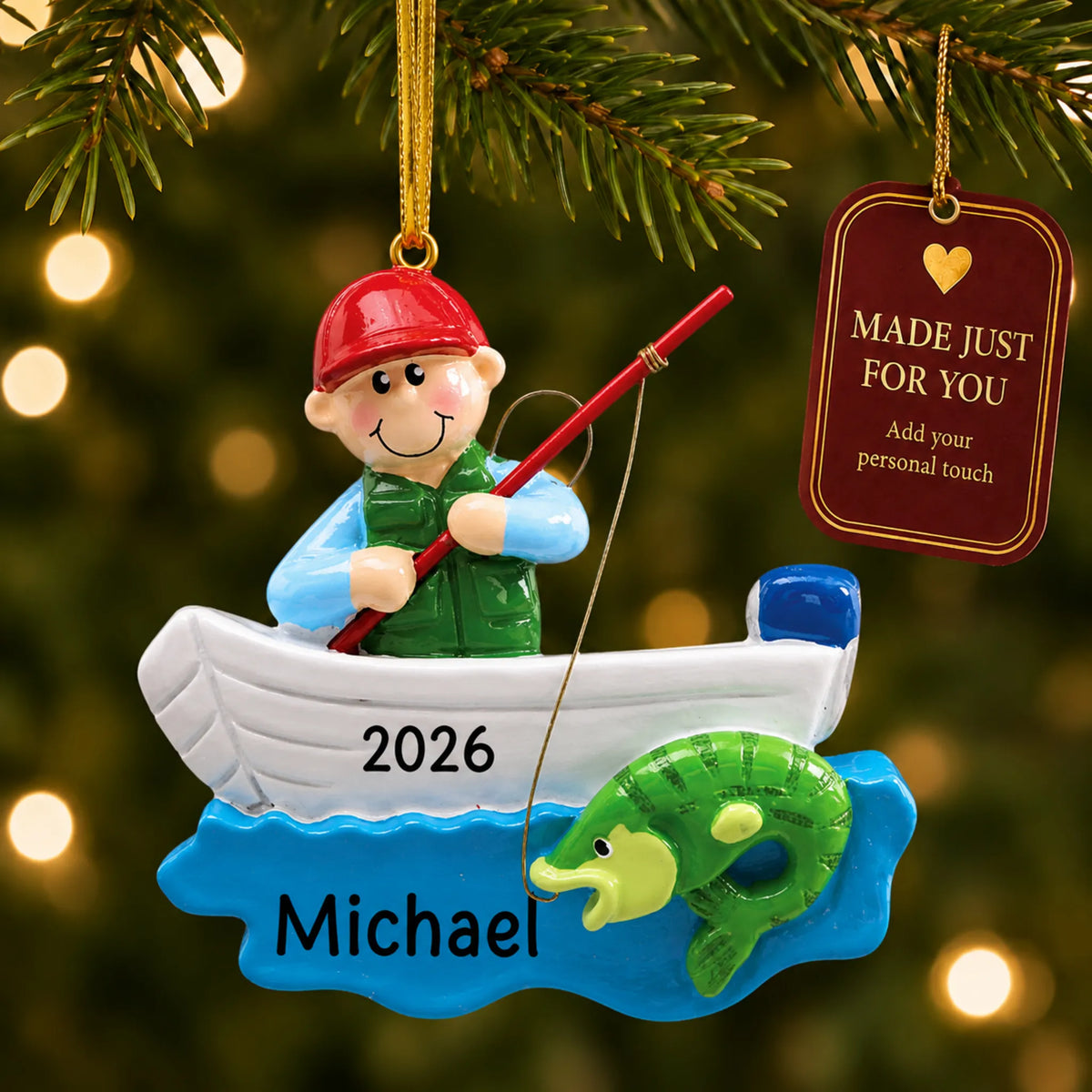 Fisherman in boat christmas ornament hanging on a lit Christmas tree with a Made Just For You gift tag