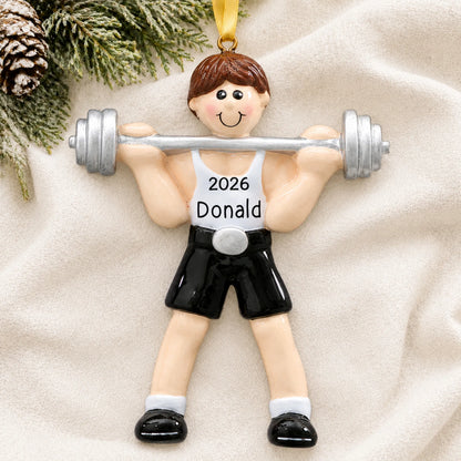 Personalized Weightlifter christmas ornament laid on a soft white knit blanket