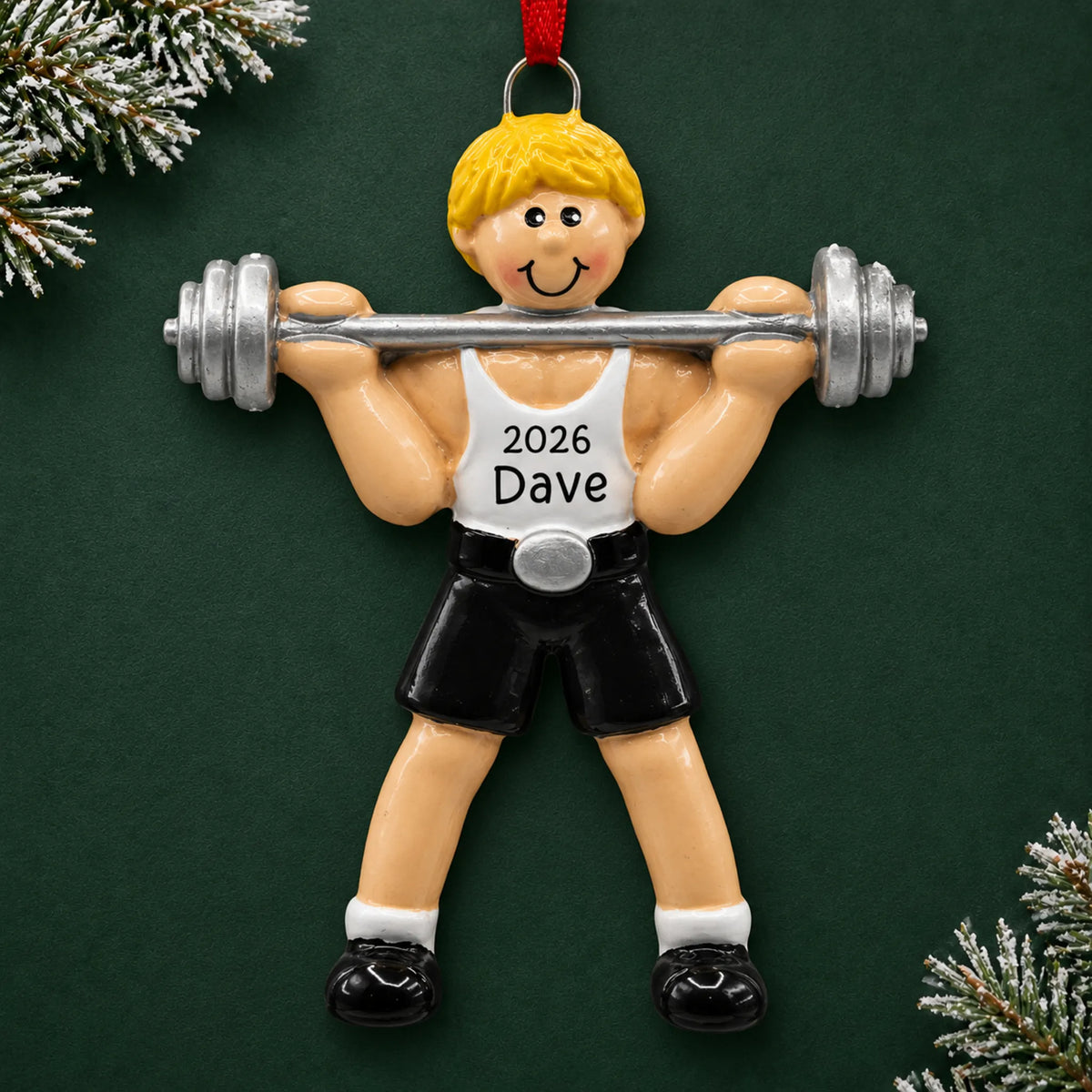 Personalized blonde weightlifter christmas ornament on a dark green pine background