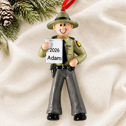 Personalized state trooper christmas ornament laid on a soft white knit blanket
