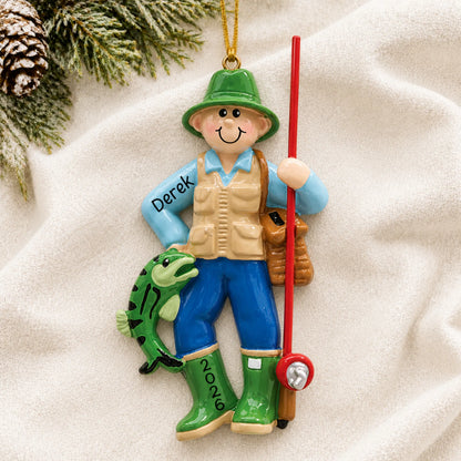 Personalized fly fisherman christmas ornament laid on a soft white knit blanket