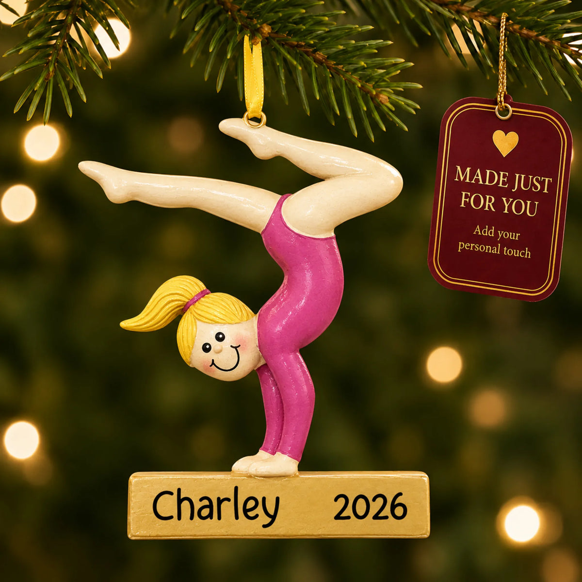 Blonde gymnast balance beam christmas ornament hanging on a lit Christmas tree with a Made Just For You gift tag