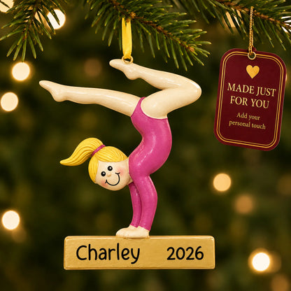 Blonde gymnast balance beam christmas ornament hanging on a lit Christmas tree with a Made Just For You gift tag