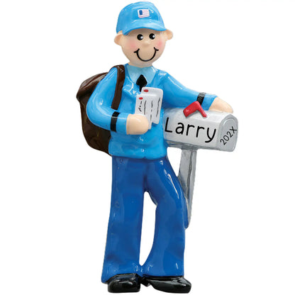 A personalized ornament featuring a smiling USPS postal worker in blue holding a mailbag and leaning on a mailbox.