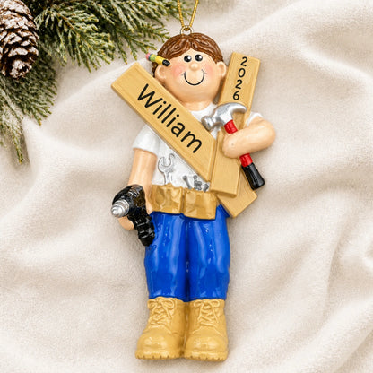 Personalized Mr. Fix It contractor christmas ornament laid on a soft white knit blanket