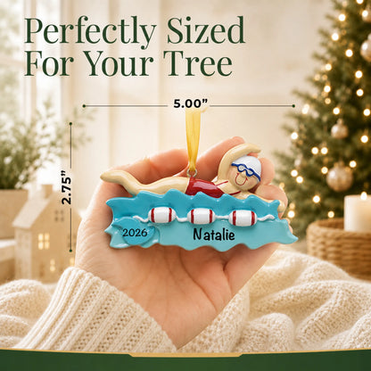 Size guide: the personalized girl swimming christmas ornament is 5.00 in wide by 2.75 in tall, shown in hand
