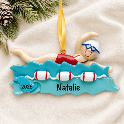 Personalized girl swimming christmas ornament laid on a soft white knit blanket