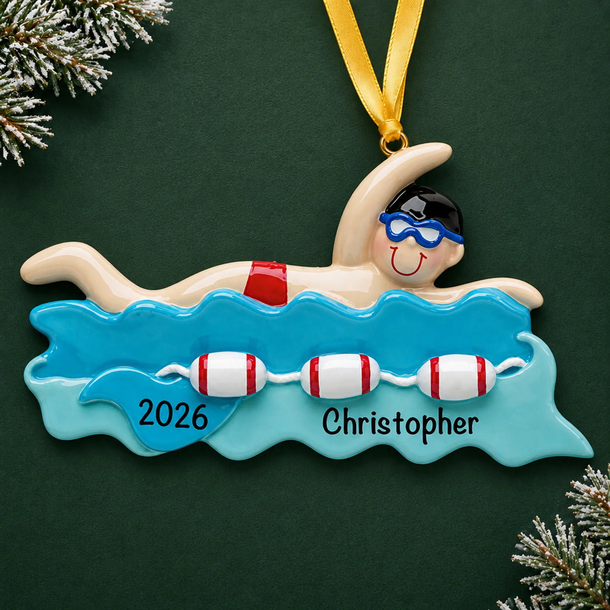 Personalized swim boy christmas ornament on a dark green pine background