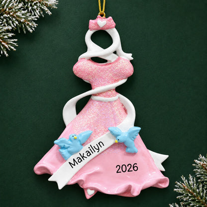 Personalized pink princess dress christmas ornament on a dark green pine background