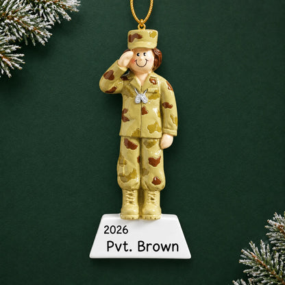 Personalized US Army girl Christmas ornament with name and year, shown on a green holiday background