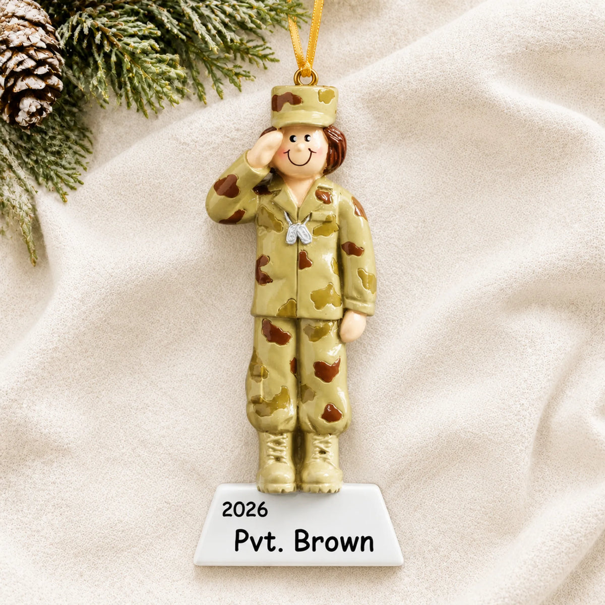 Personalized US Army girl Christmas ornament shown on a soft white blanket