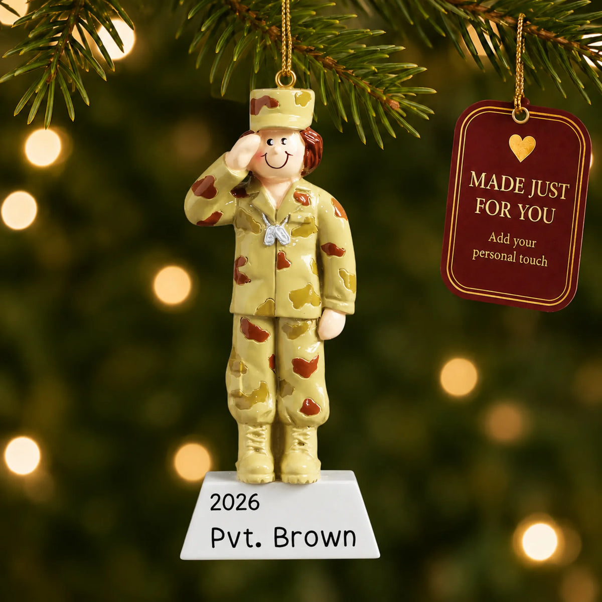Personalized US Army girl Christmas ornament hanging among tree lights with a Made Just For You tag