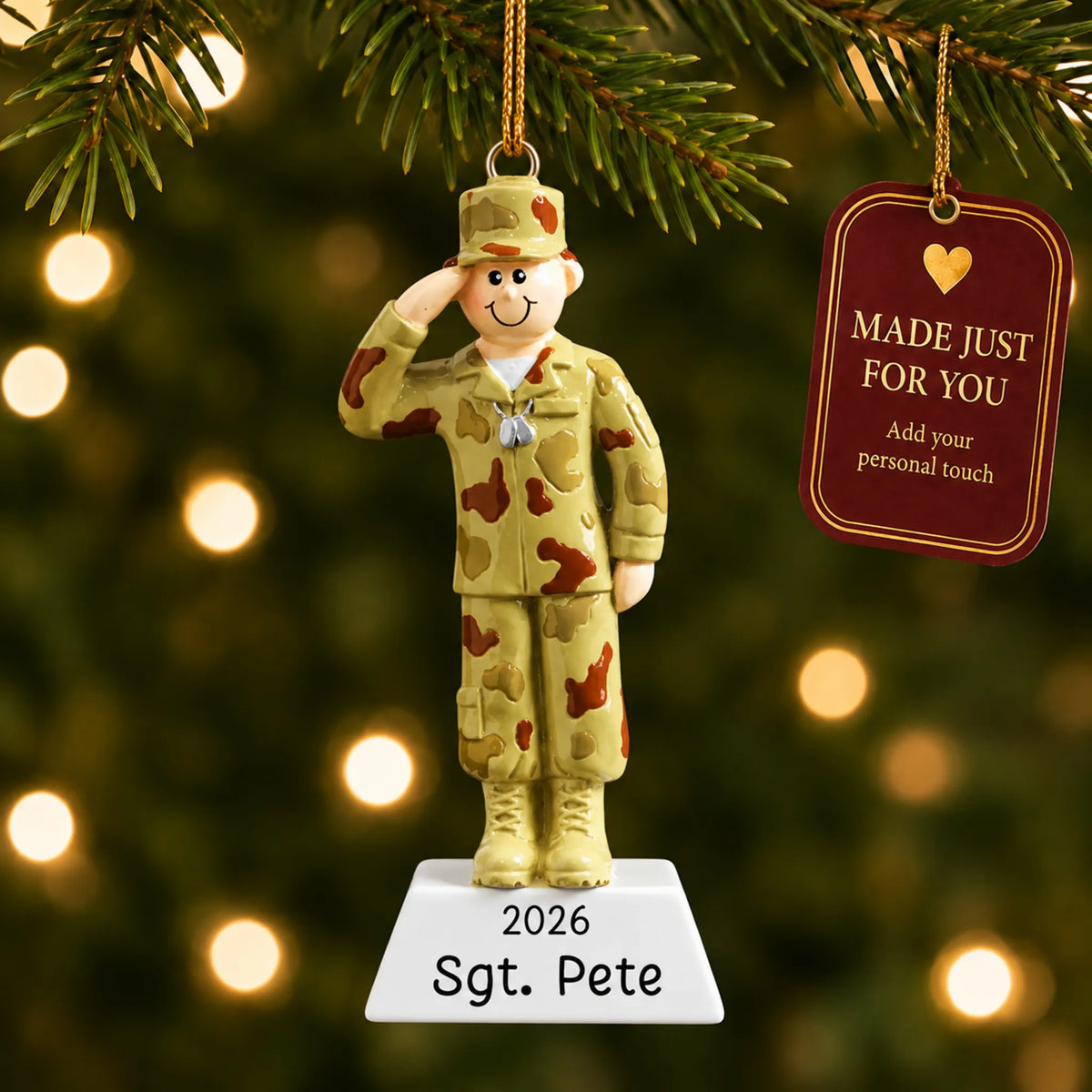 Personalized Army soldier Christmas ornament hanging among tree lights with a Made Just For You tag