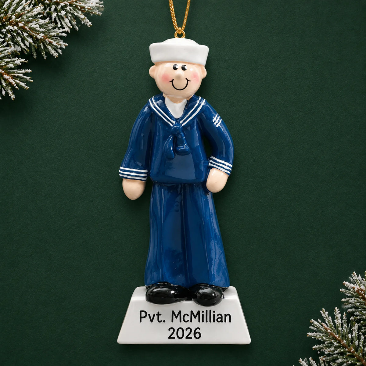 Personalized Navy sailor Christmas ornament with name and year, shown on a green holiday background