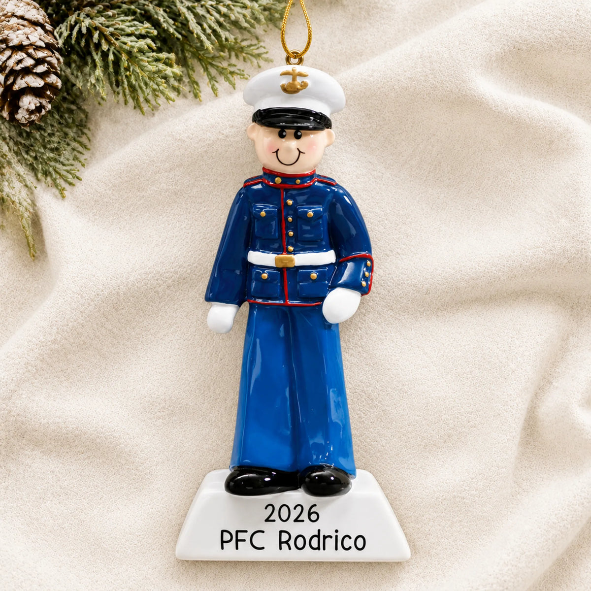 Personalized US Marine Christmas ornament shown on a soft white blanket