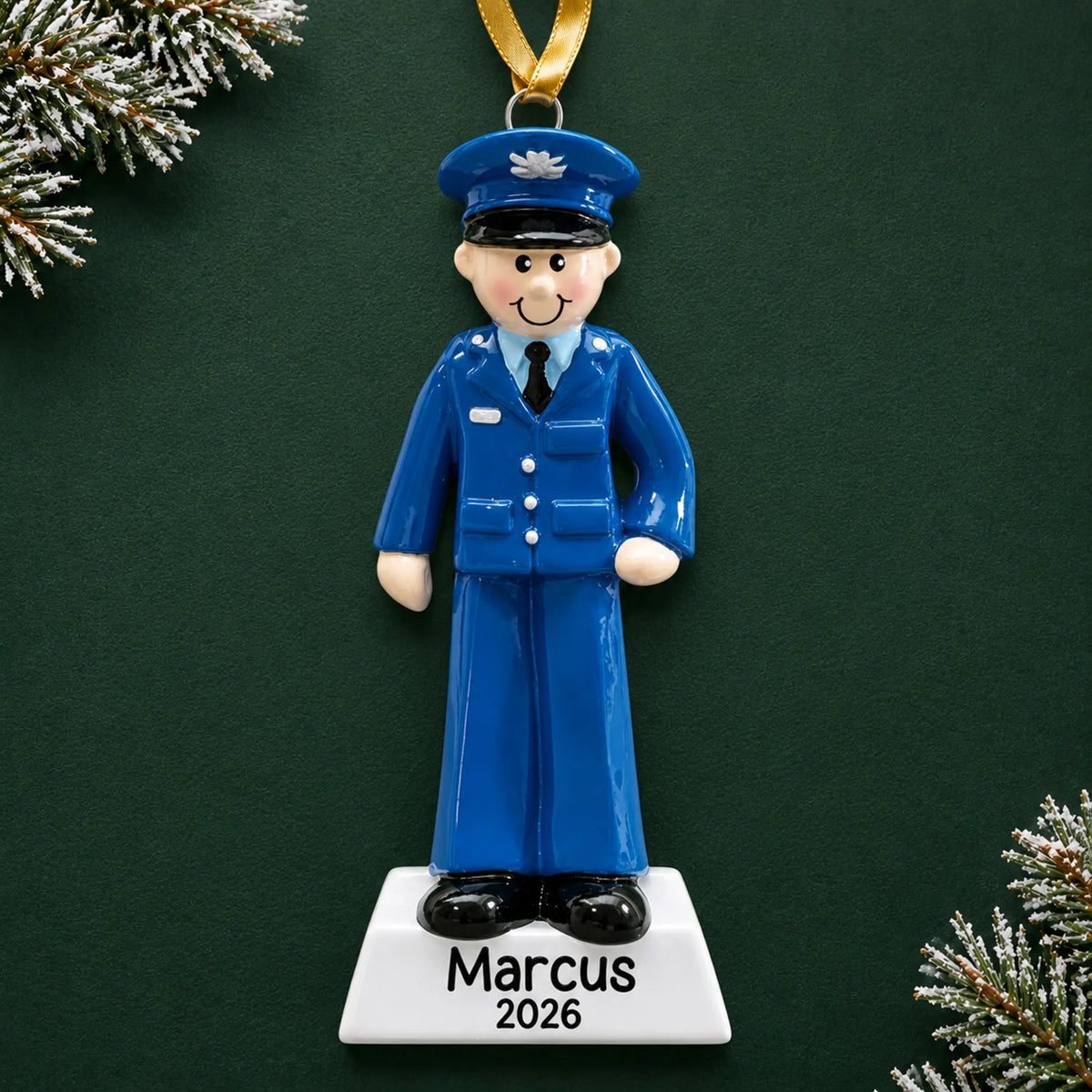 Personalized US Air Force airman Christmas ornament with name and year, shown on a green holiday background