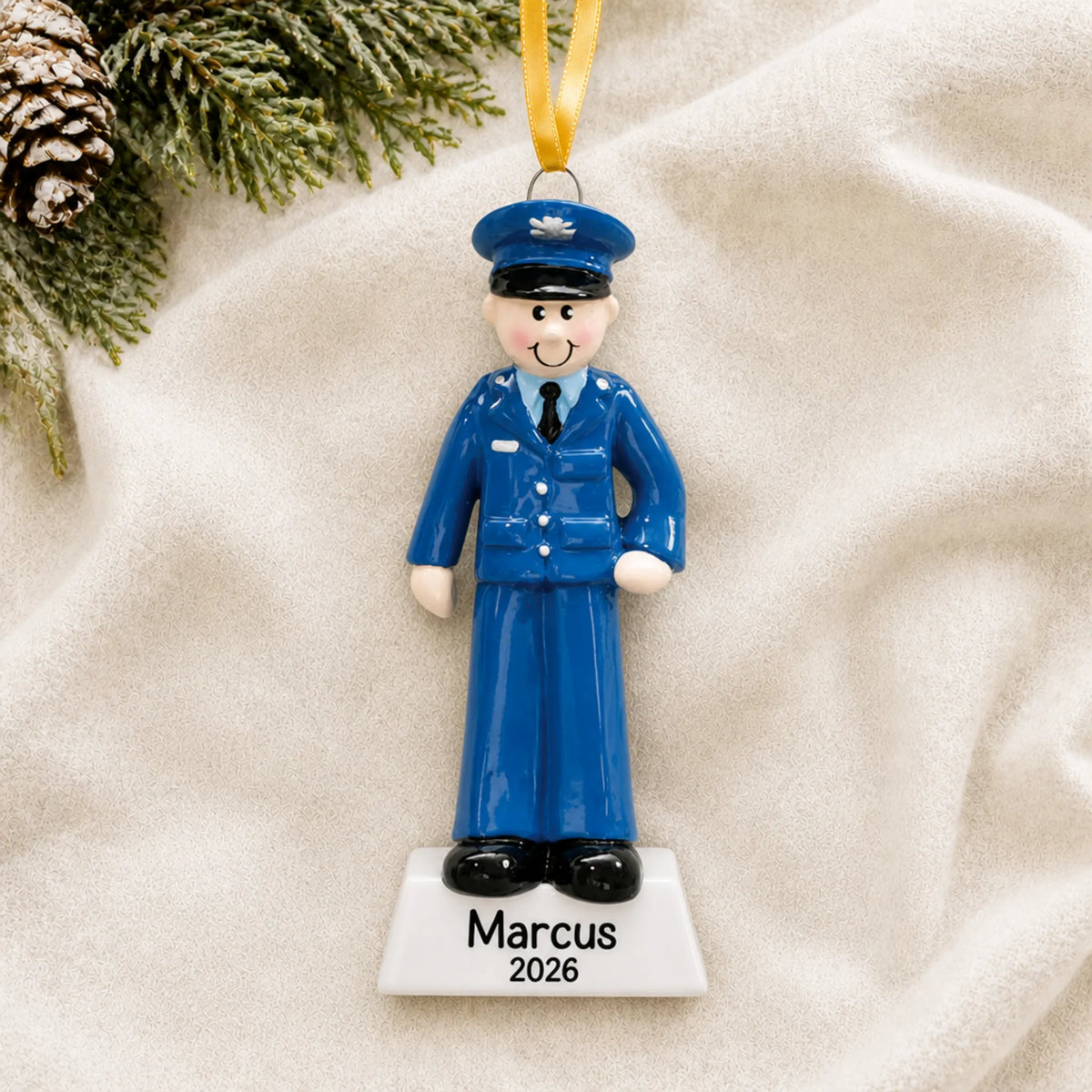 Personalized US Air Force airman Christmas ornament shown on a soft white blanket
