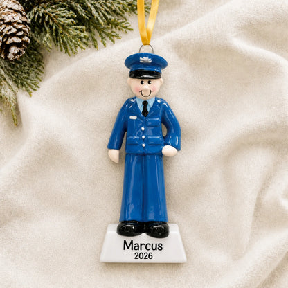 Personalized US Air Force airman Christmas ornament shown on a soft white blanket