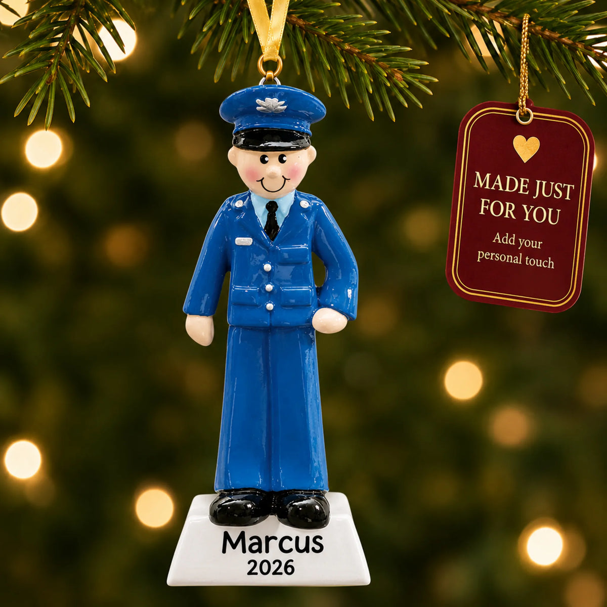 Personalized US Air Force airman Christmas ornament hanging among tree lights with a Made Just For You tag
