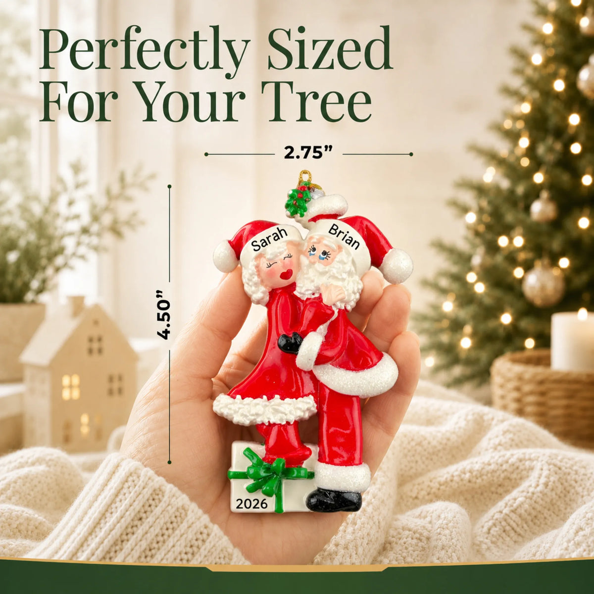 Size guide: the personalized mr. and mrs. claus couple christmas ornament is 2.75 in wide by 4.50 in tall, shown in hand