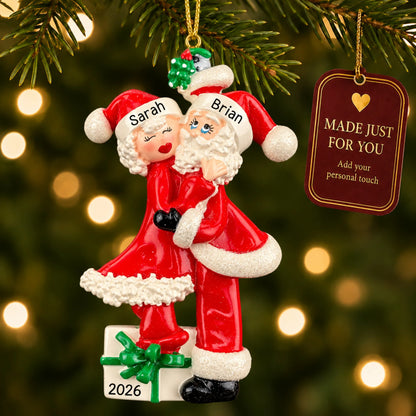 Mr. and mrs. claus couple christmas ornament hanging on a lit Christmas tree with a Made Just For You gift tag