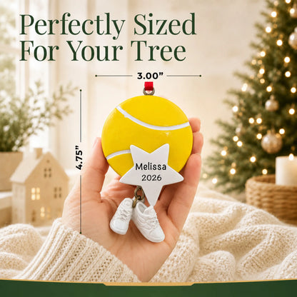Size guide: the personalized tennis star christmas ornament shown in hand next to a Christmas tree