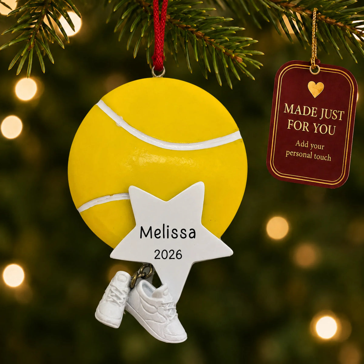 Tennis star christmas ornament hanging on a lit Christmas tree with a Made Just For You gift tag