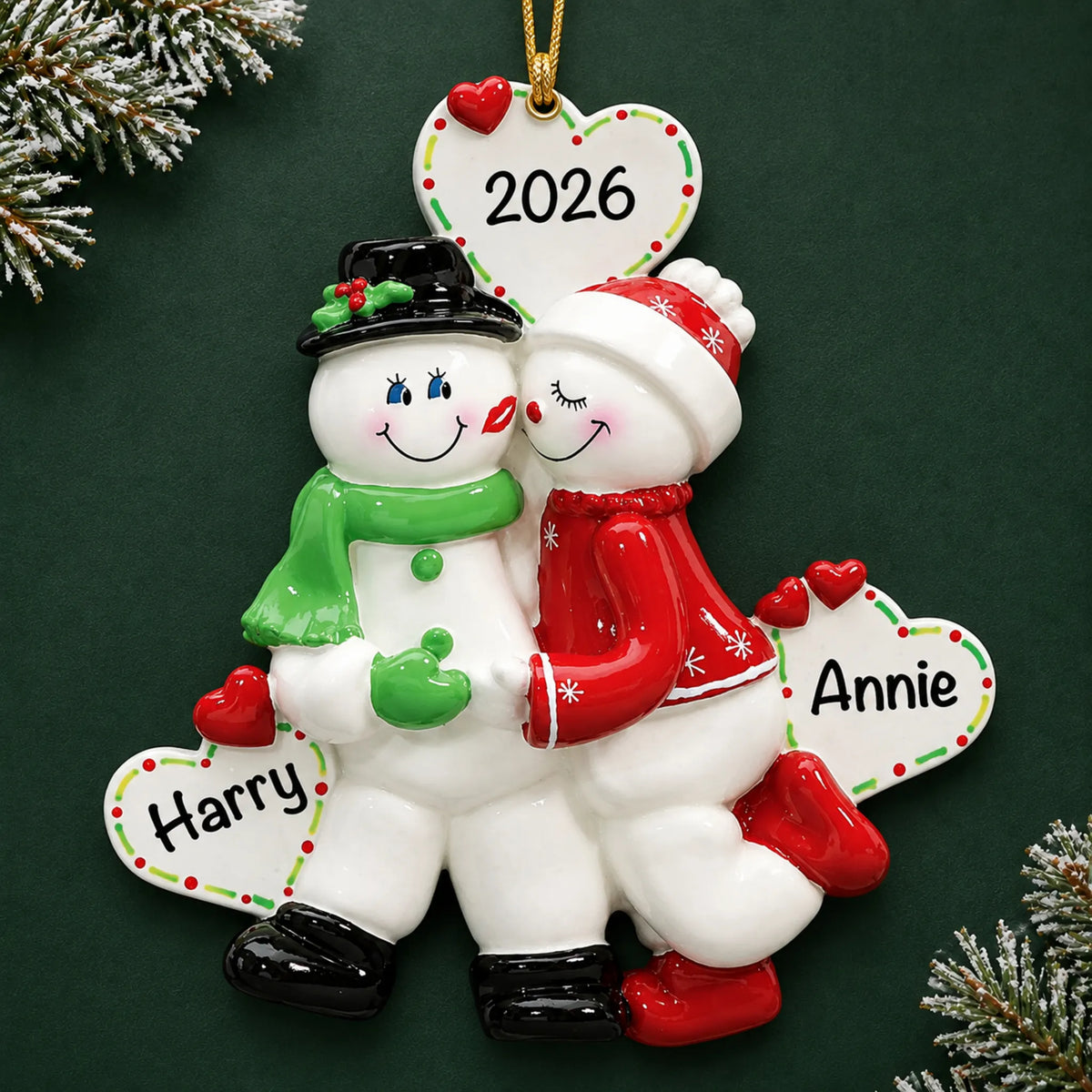 Personalized snow sweethearts couple christmas ornament on a dark green pine background