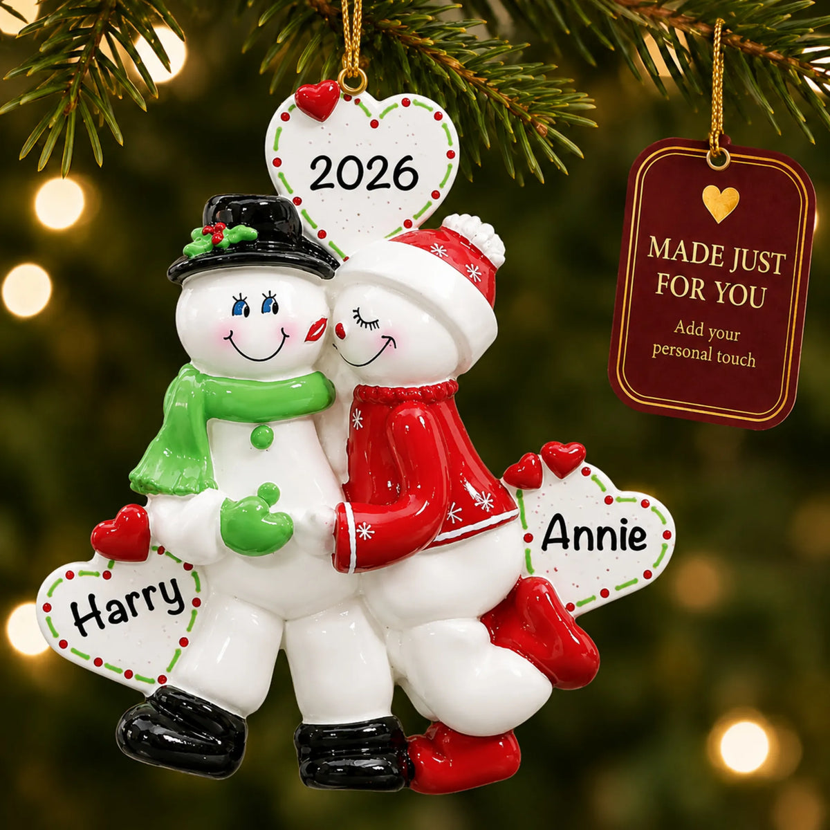 Snow sweethearts couple christmas ornament hanging on a lit Christmas tree with a Made Just For You gift tag