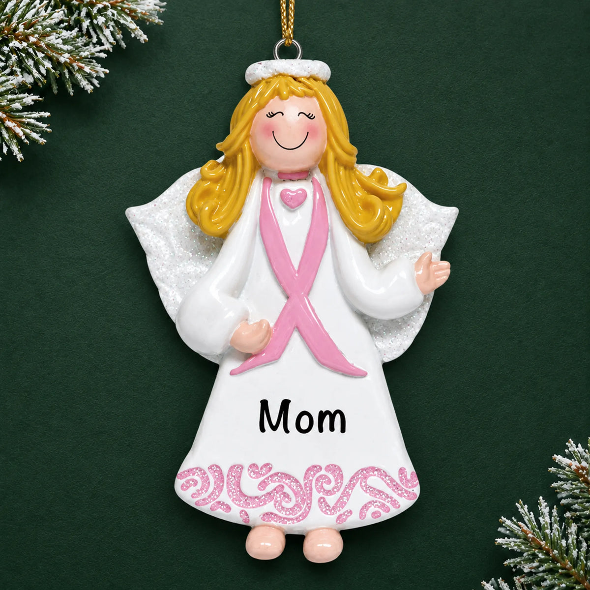 Personalized Pink Ribbon Angel christmas ornament on a dark green pine background