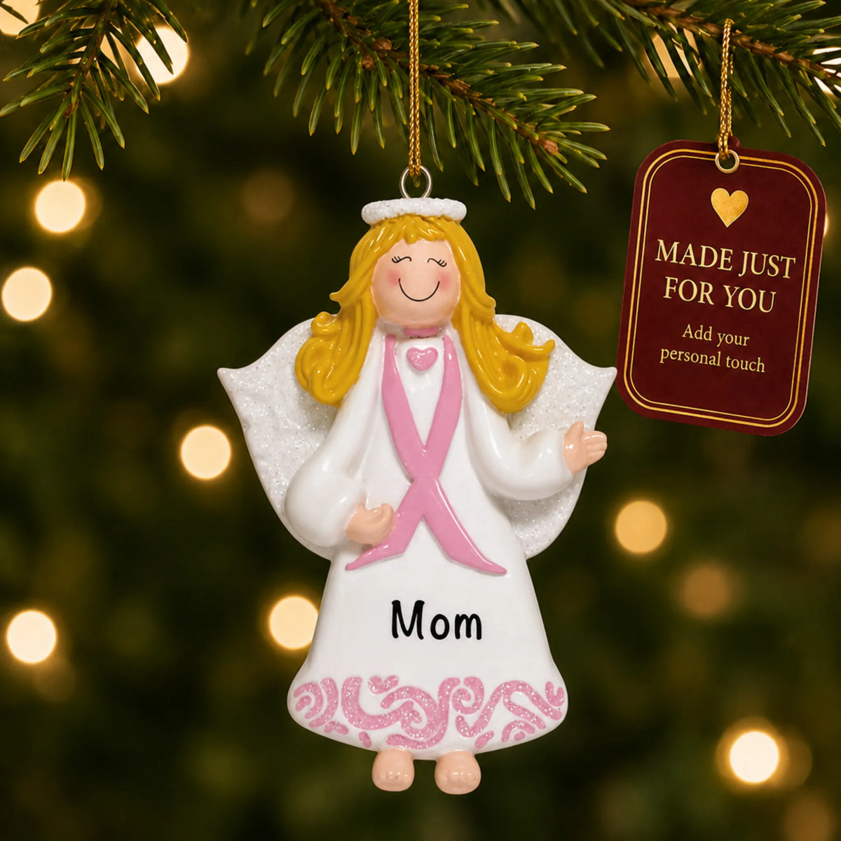 Pink Ribbon Angel christmas ornament hanging on a lit Christmas tree with a Made Just For You gift tag